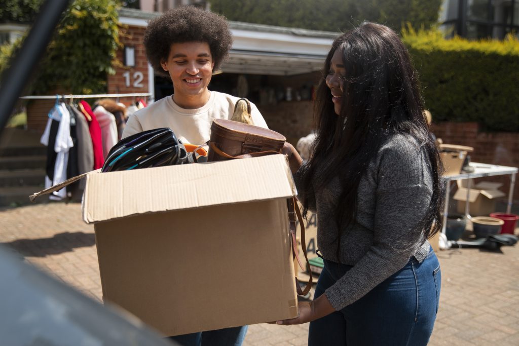 Volunteers carrying a box of donated goods for wildfire relief