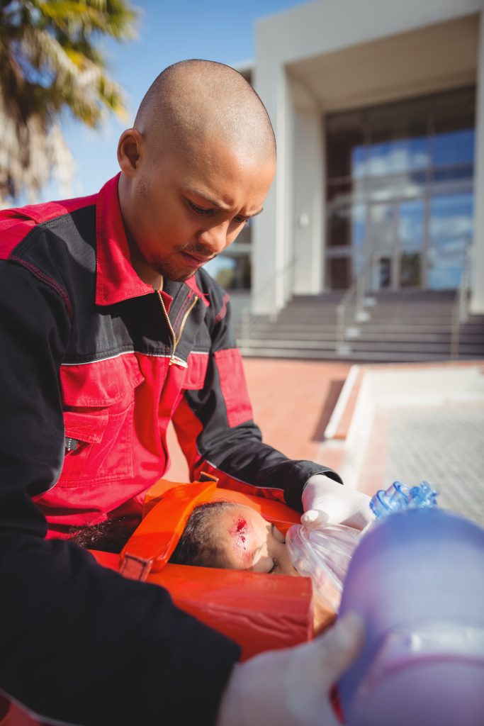 Relief volunteer assisting a wildfire evacuee with supplies