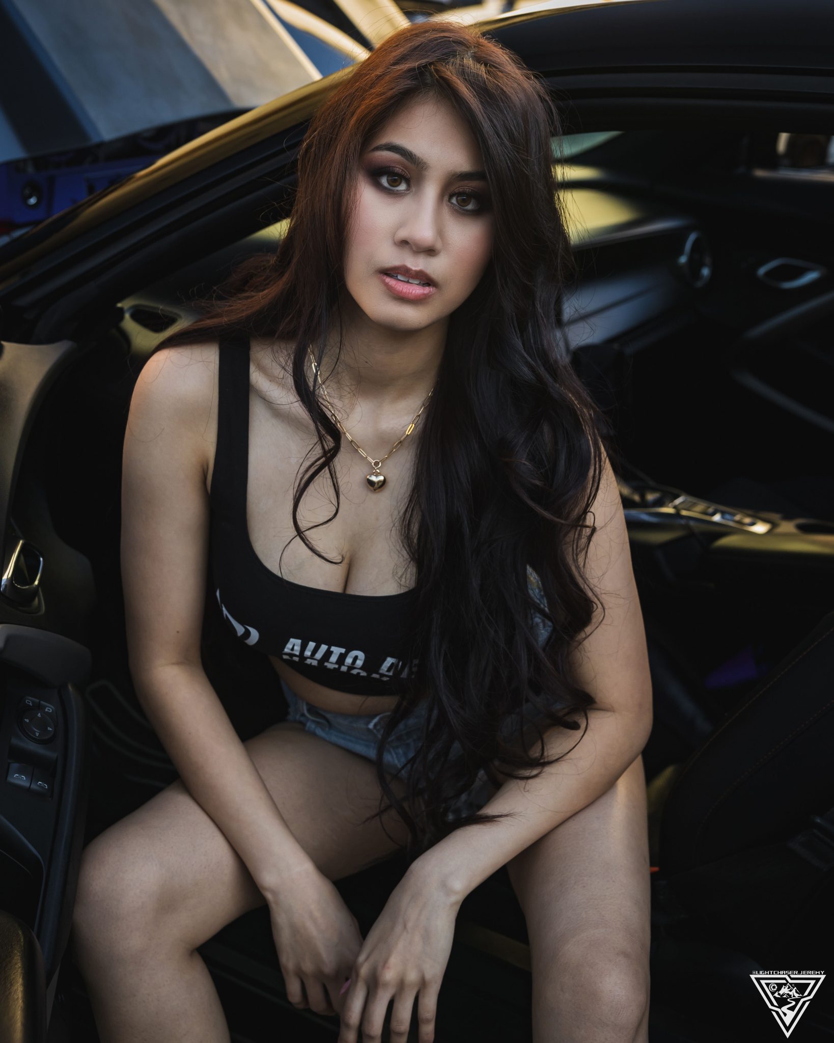 Seated portrait of Joan Cruz in Auto Detail Nation gear