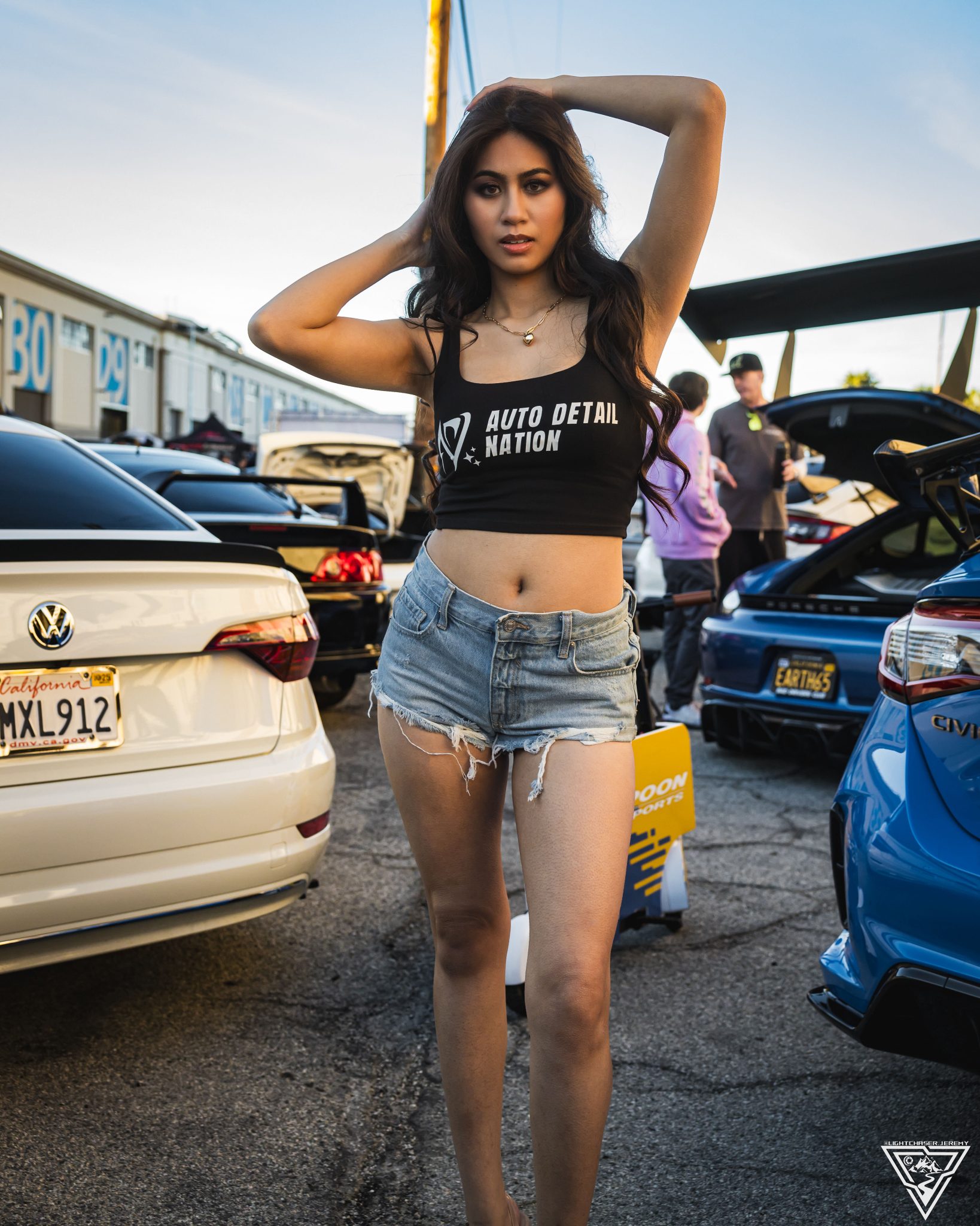 Joan Cruz in an Auto Detail Nation top at a car meet