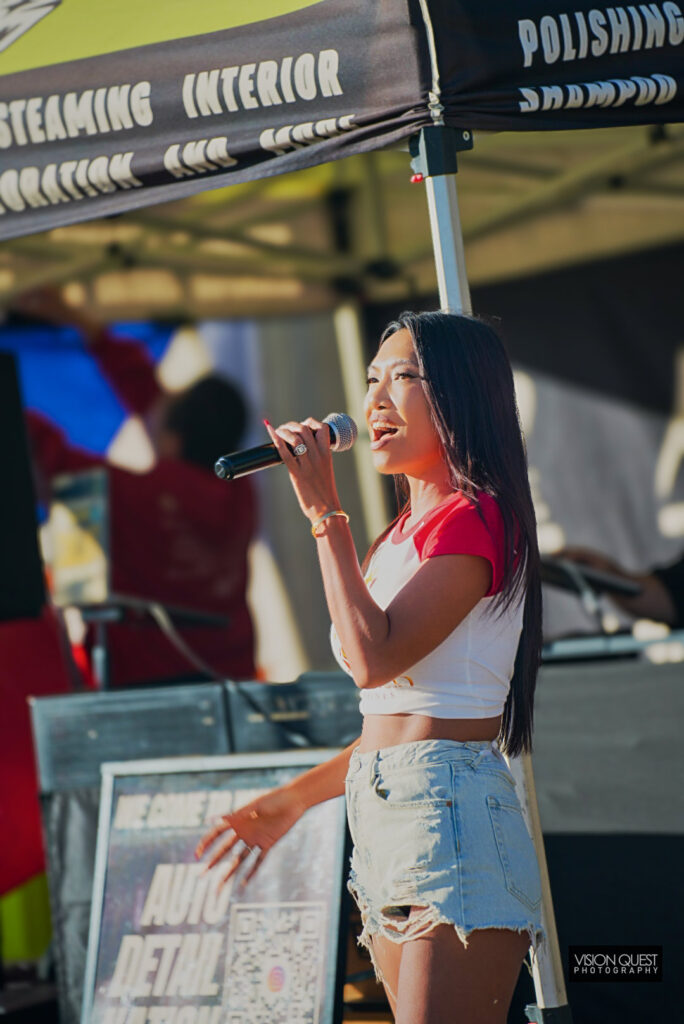 Live singer performing at the Auto Detail Nation booth, Just Anoth3r Car Show