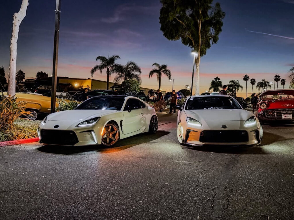 Two white sports cars at sunset at Just Anoth3r Car Show, Cafe 86 Placentia